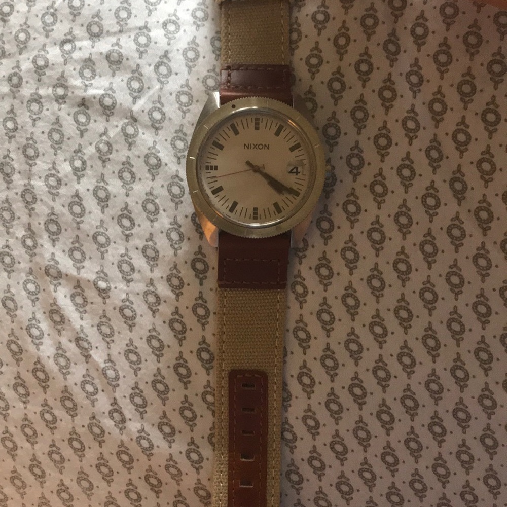 Nixon watch with tan canvas band.